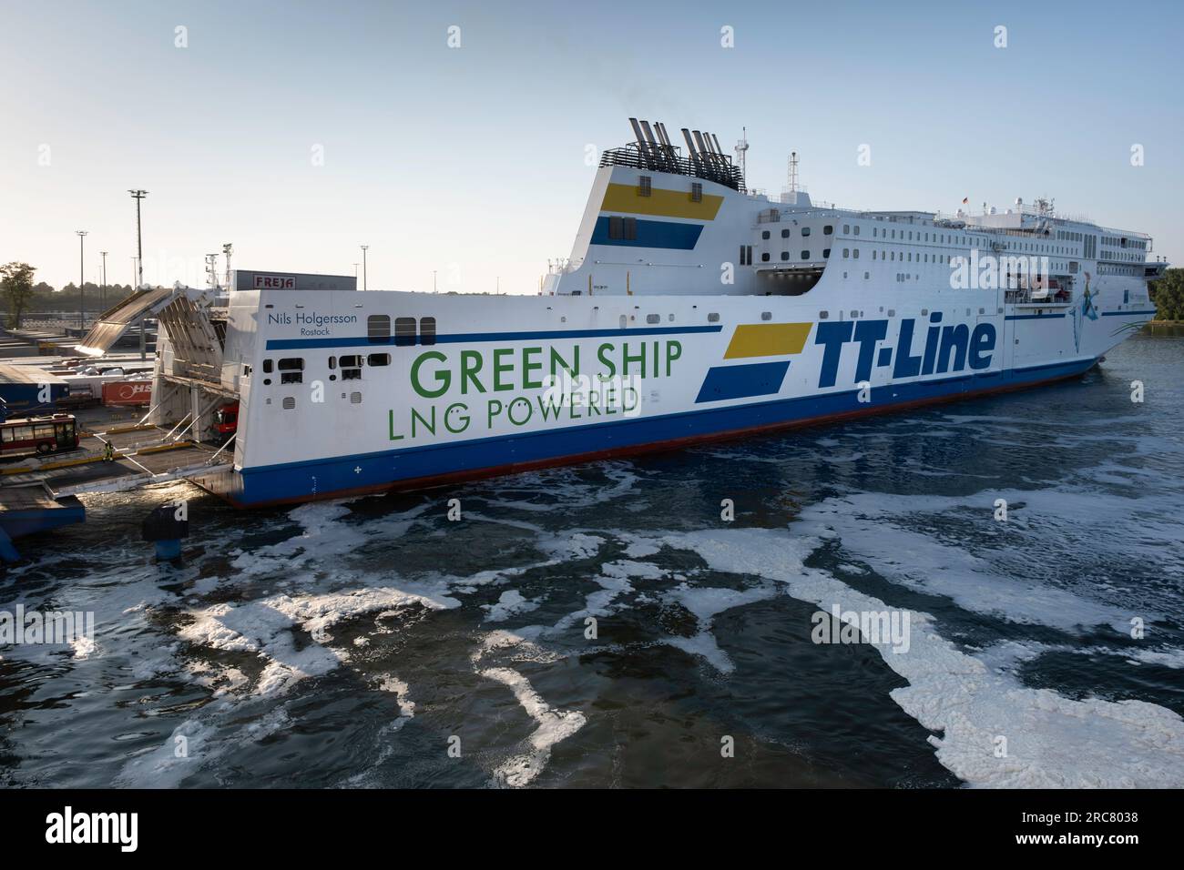 Trucks leave the Green ship TT-Line ferry NILS HOLGERSSON, LNG Powered, in the harbor of Travemünde Stock Photo