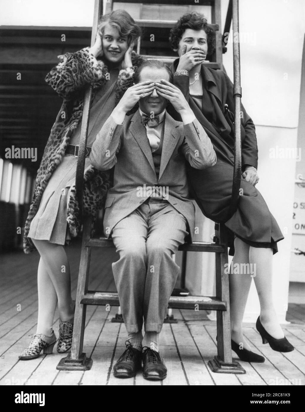 Seattle, Washington:  c. 1933 Three passengers enroute from the Orient to Seattle on the SS President Jefferson honor the traditional Japanese monkey gods of Hear, See, and Speak No Evil. Stock Photo