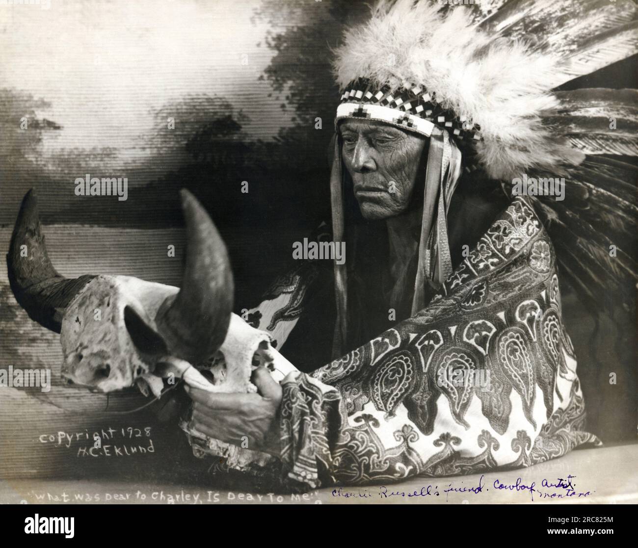 Montana:  1928  Photograph of Cree Chief Mo-See-Ma-Ma-Mos, Young Boy, holding a buffalo skull. He was western artist Charlie Russell's good friend and favorite model. Stock Photo