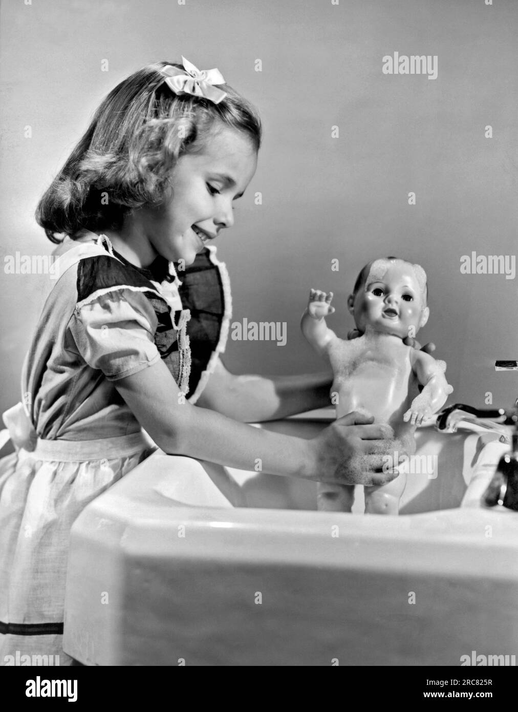 United States 1949. A young girl plays with her new allvinyl plastic