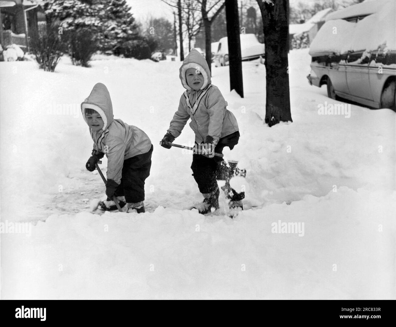 Pennsylvania c. 1954 Two small children in matching outfits shovel