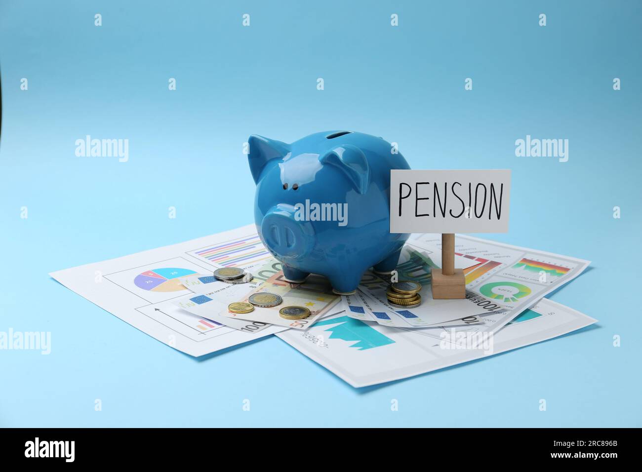 Pension savings. Piggy bank, cash and graphs on light blue background