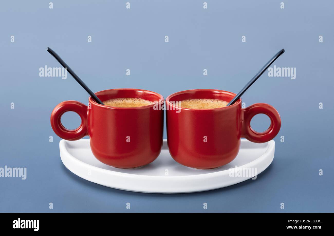 Two small cute red cups filled with espresso Stock Photo