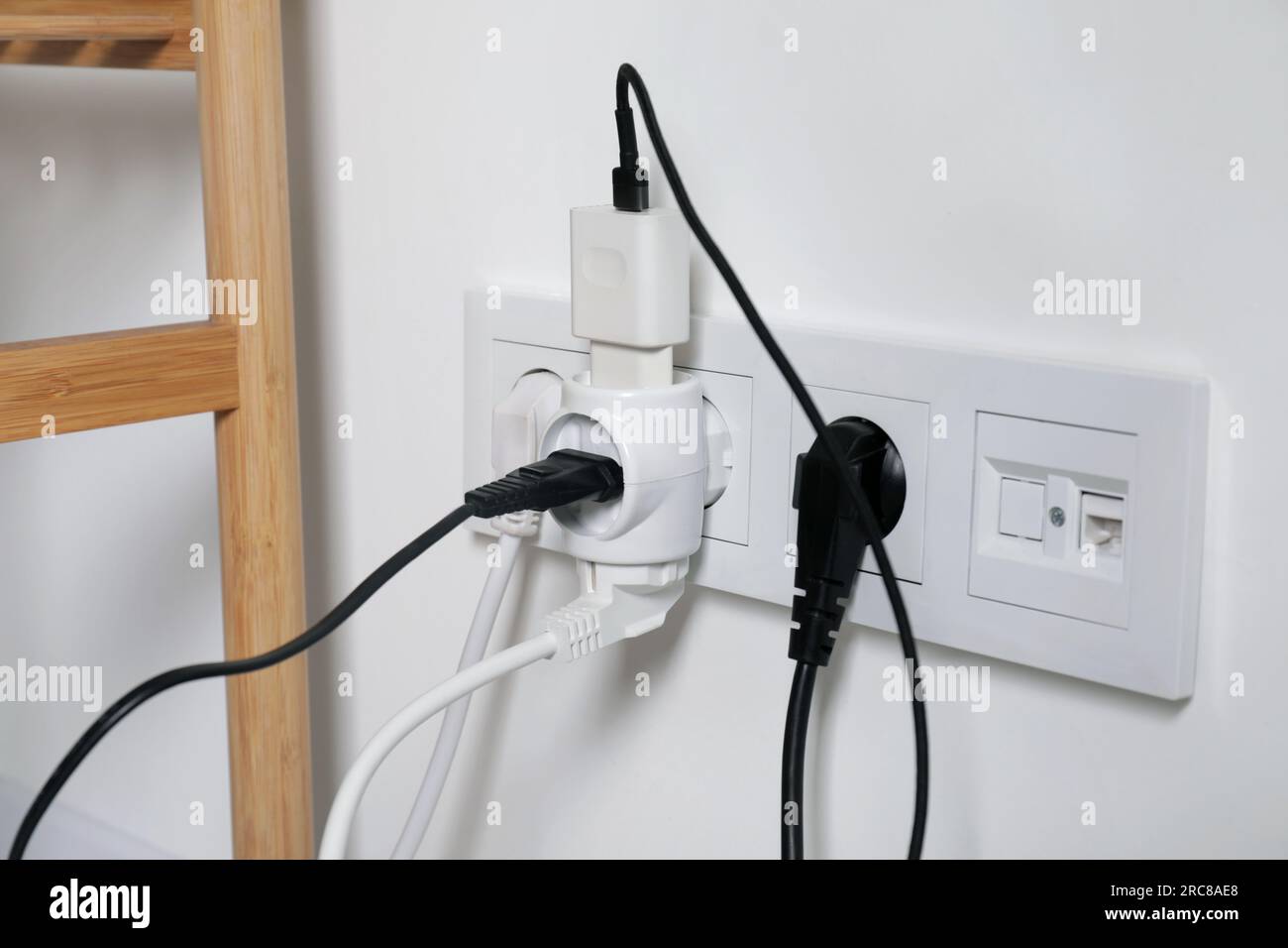 Many different electrical power plugs in sockets indoors Stock Photo