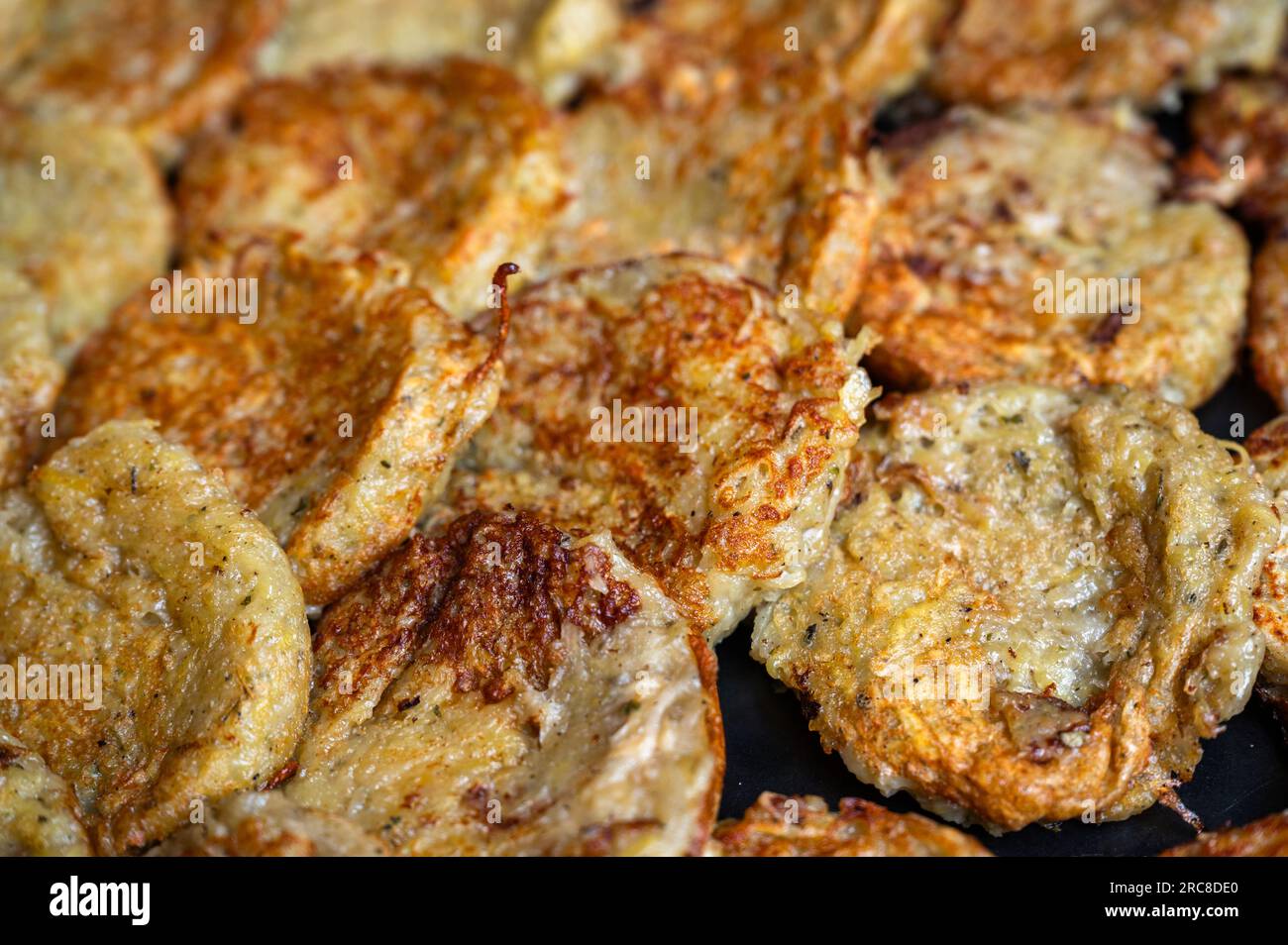 Texture and structure of potato pancake stacked in pan, closeup. Stock Photo