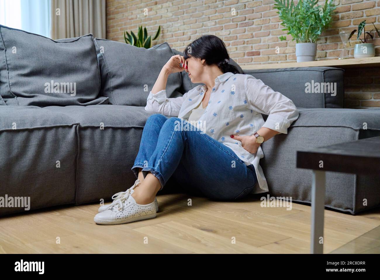 Mature woman suffering from physical pain, mental problems Stock Photo