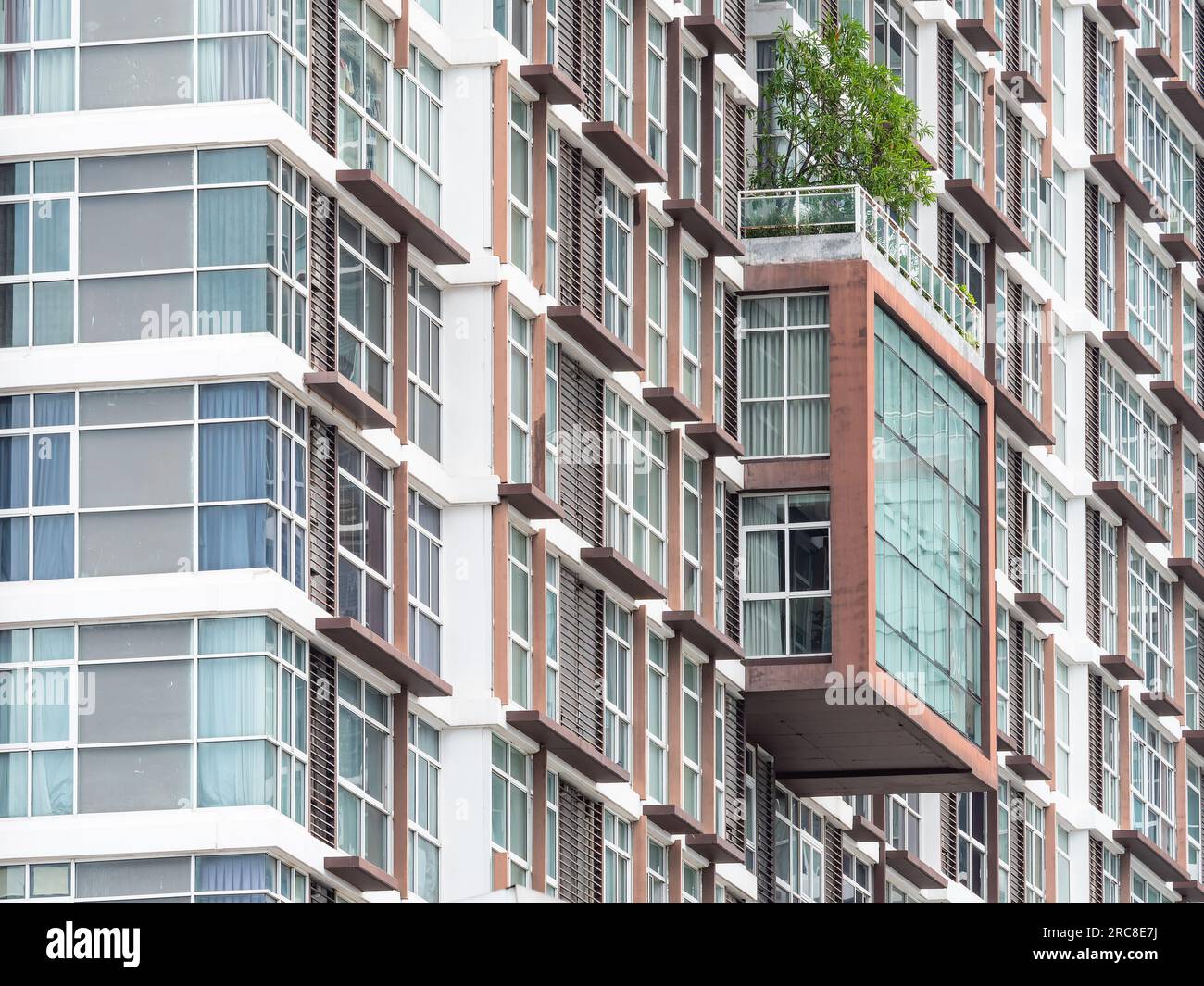 Facade of high rise condominium building in Bang Na on the outskirts of Bangkok, Thailand. Stock Photo