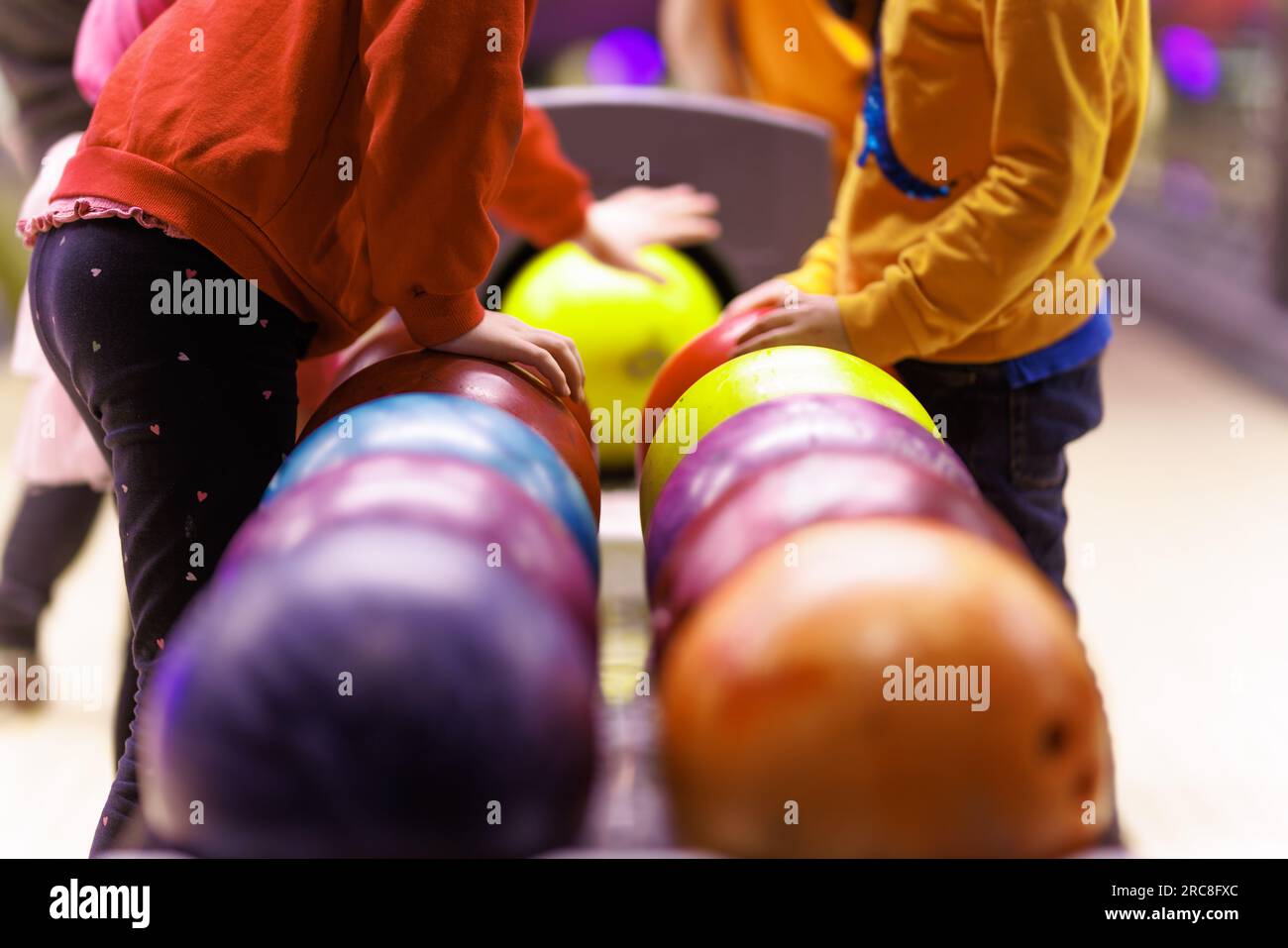 Children are playing bowling. Extracurricular activities for children
