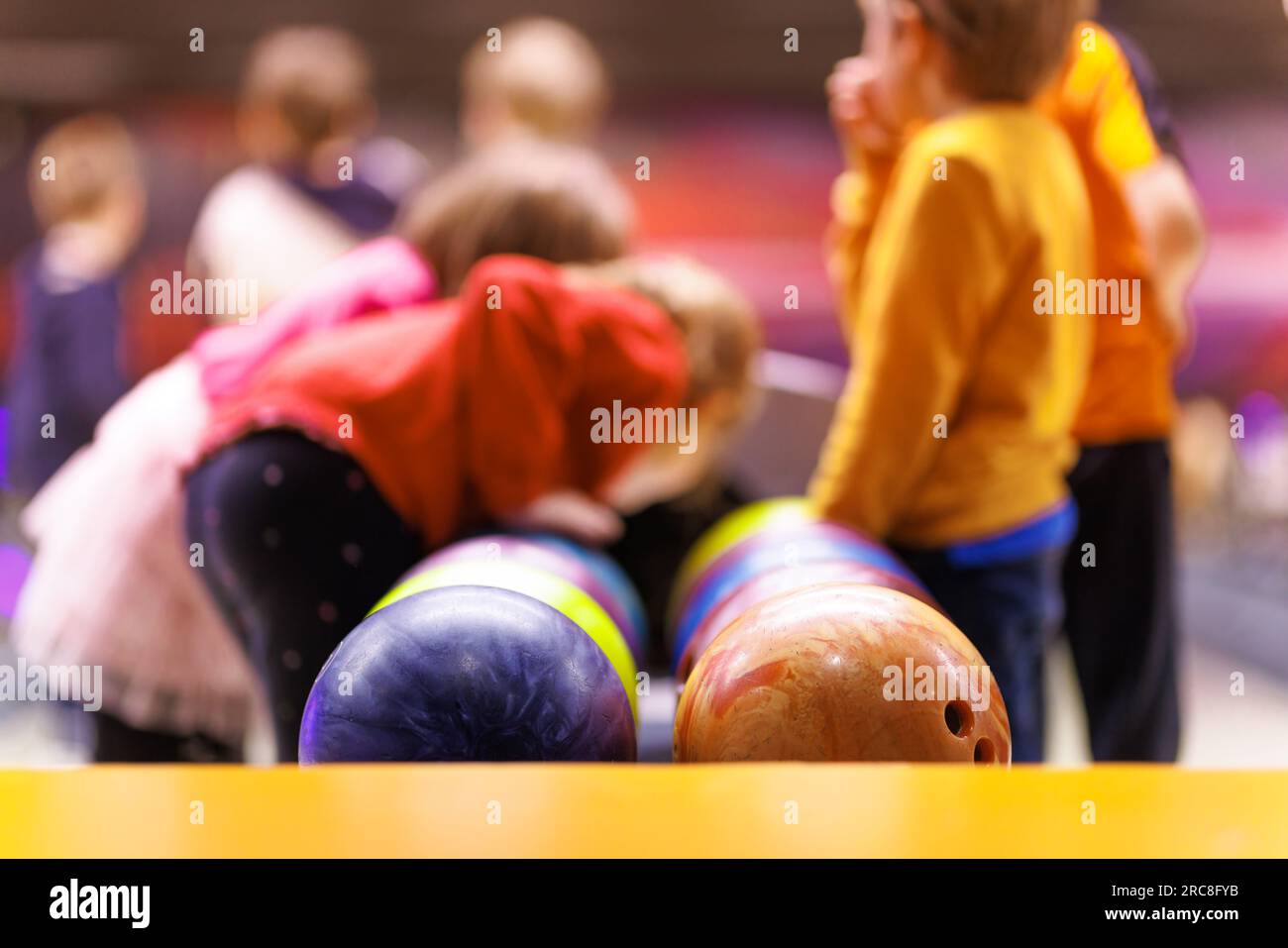 Children are playing bowling. Extracurricular activities for children