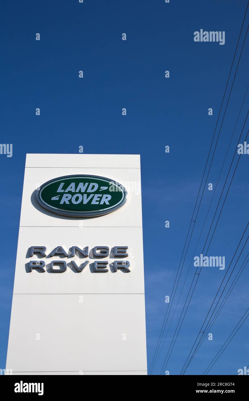 Land Rover car dealership sign against blue sky Stock Photo Alamy
