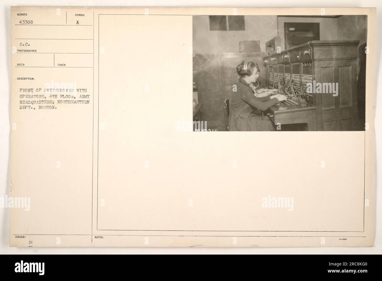 A photograph showing a front view of a switchboard with operators on ...