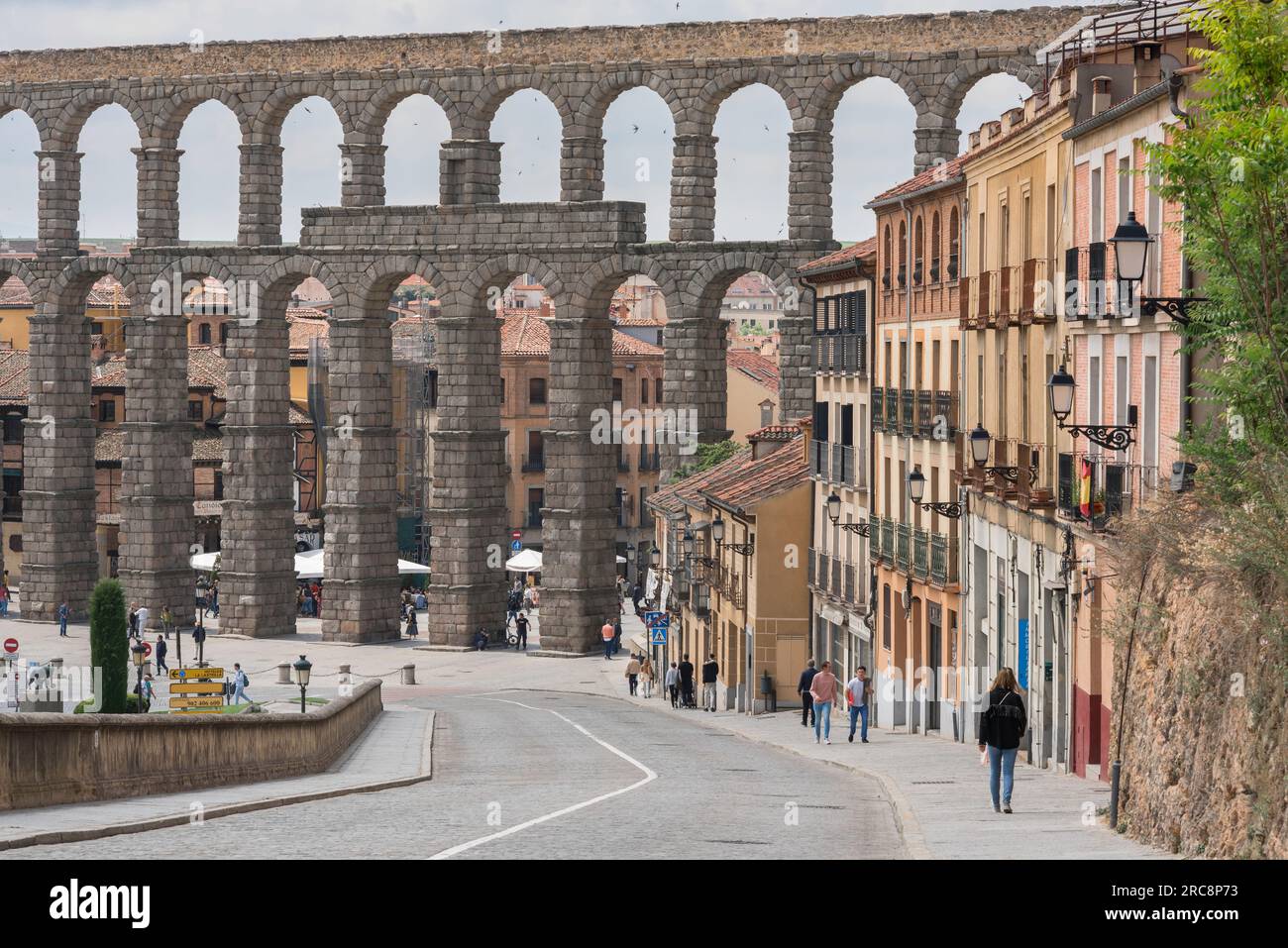 Roman architecture Segovia, view along Calle San Juan towards the 1st Century Roman aqueduct spanning the historic city of Segovia, central Spain Stock Photo
