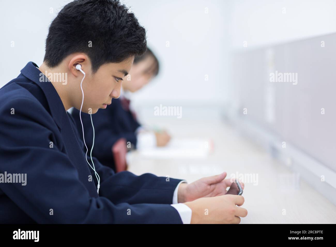 Image showcasing Students studying on their phones Stock Photo - Alamy