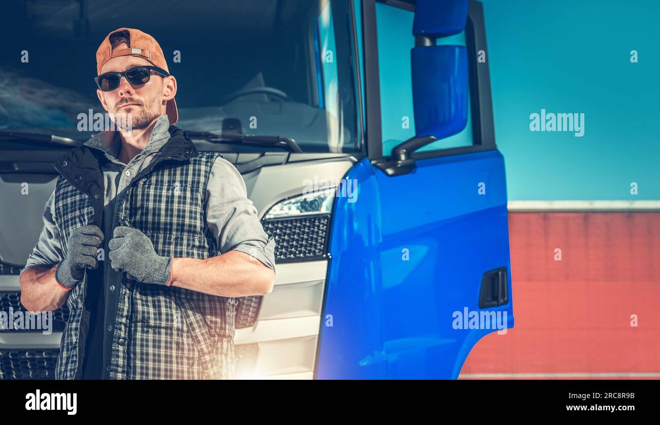 Relaxed Caucasian Truck Driver Seating on the Ground and Support His Back  on the Semi Truck Wheel Stock Photo - Alamy