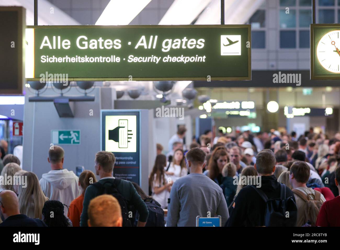 Hamburg, Germany. 13th July, 2023. Travelers stand in queues at the security checkpoint at Hamburg Airport. Hamburg Airport expects up to 350,000 passengers a week at the start of the vacation season. Credit: Bodo Marks/Bodo Marks/dpa/Alamy Live News Stock Photo