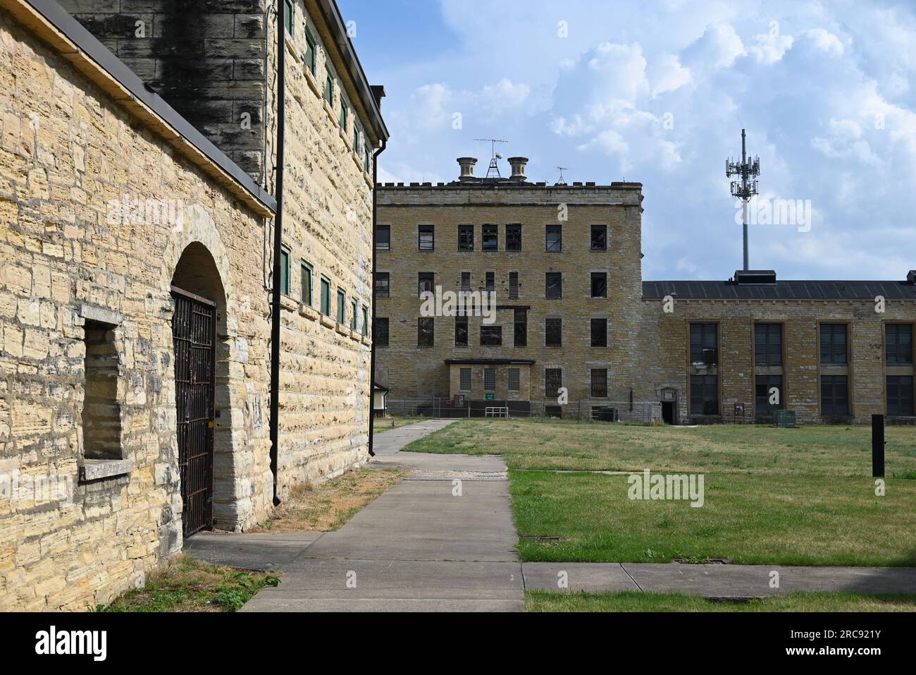 Looking past the Death Row House to the old cell block building at the Old Joliet Prison, which opened in 1858 and was closed and abandoned in 2002. Stock Photo