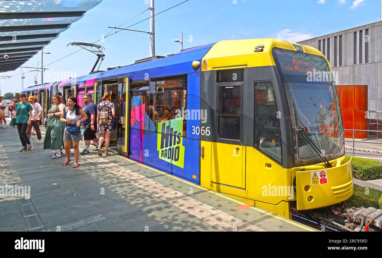 Yellow Manchester Metrolink Ashton tram, at Castlefield Deansgate, city centre, England, UK, M3 4LG Stock Photo
