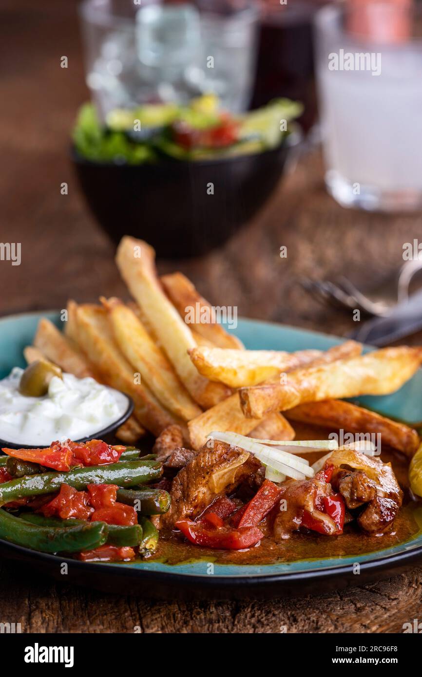 greek gyros with metaxa sauce and fries Stock Photo Alamy