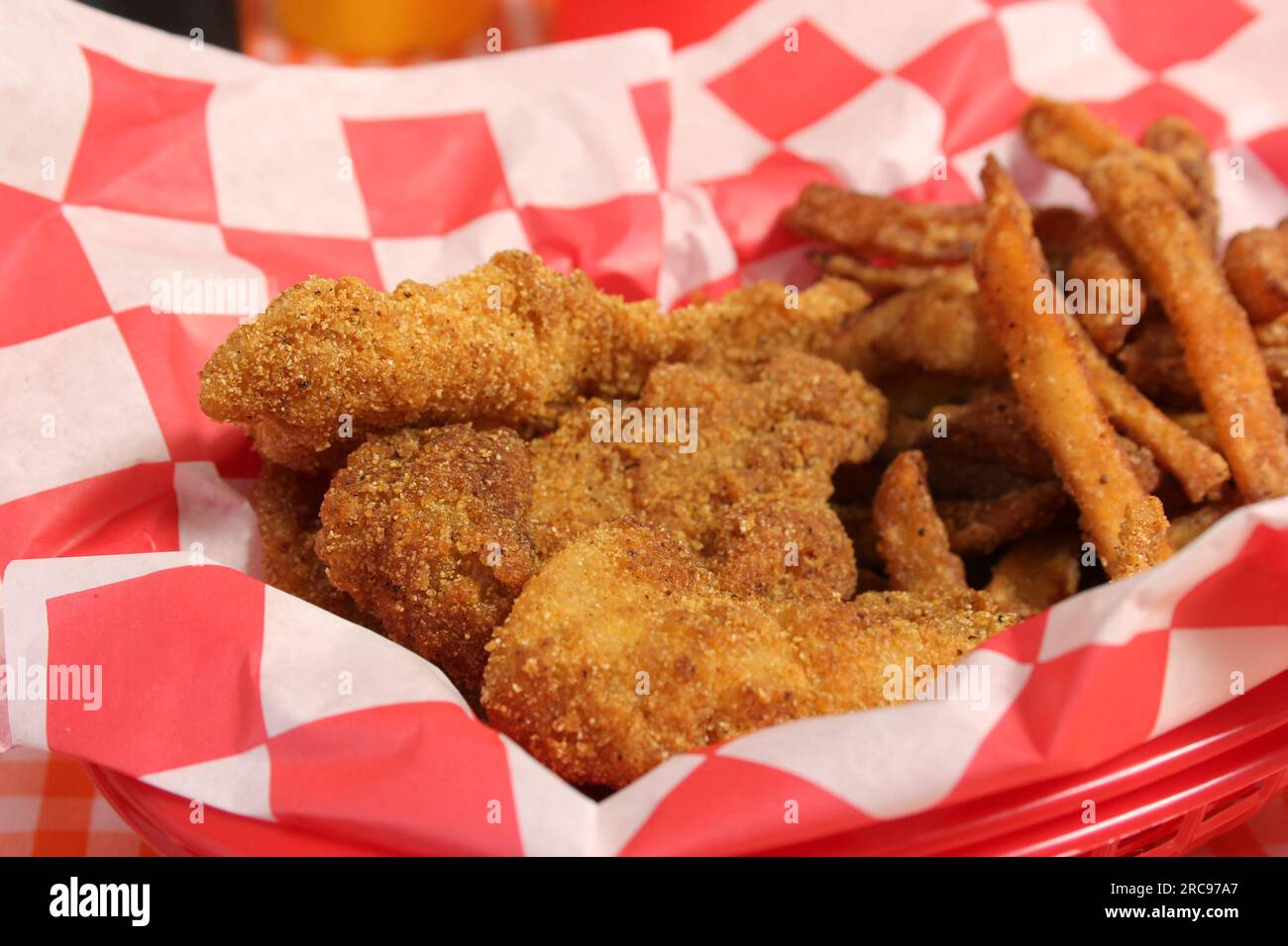 Fried Catfish Basket With French Fries in Rustic Cafe on Checkered