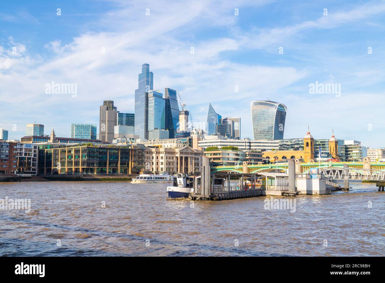 LONDON, UK - 6TH JULY 2023: Bankside Pier and the City of London cityscape during the day. Buildings, boats and people can be seen. Stock Photo
