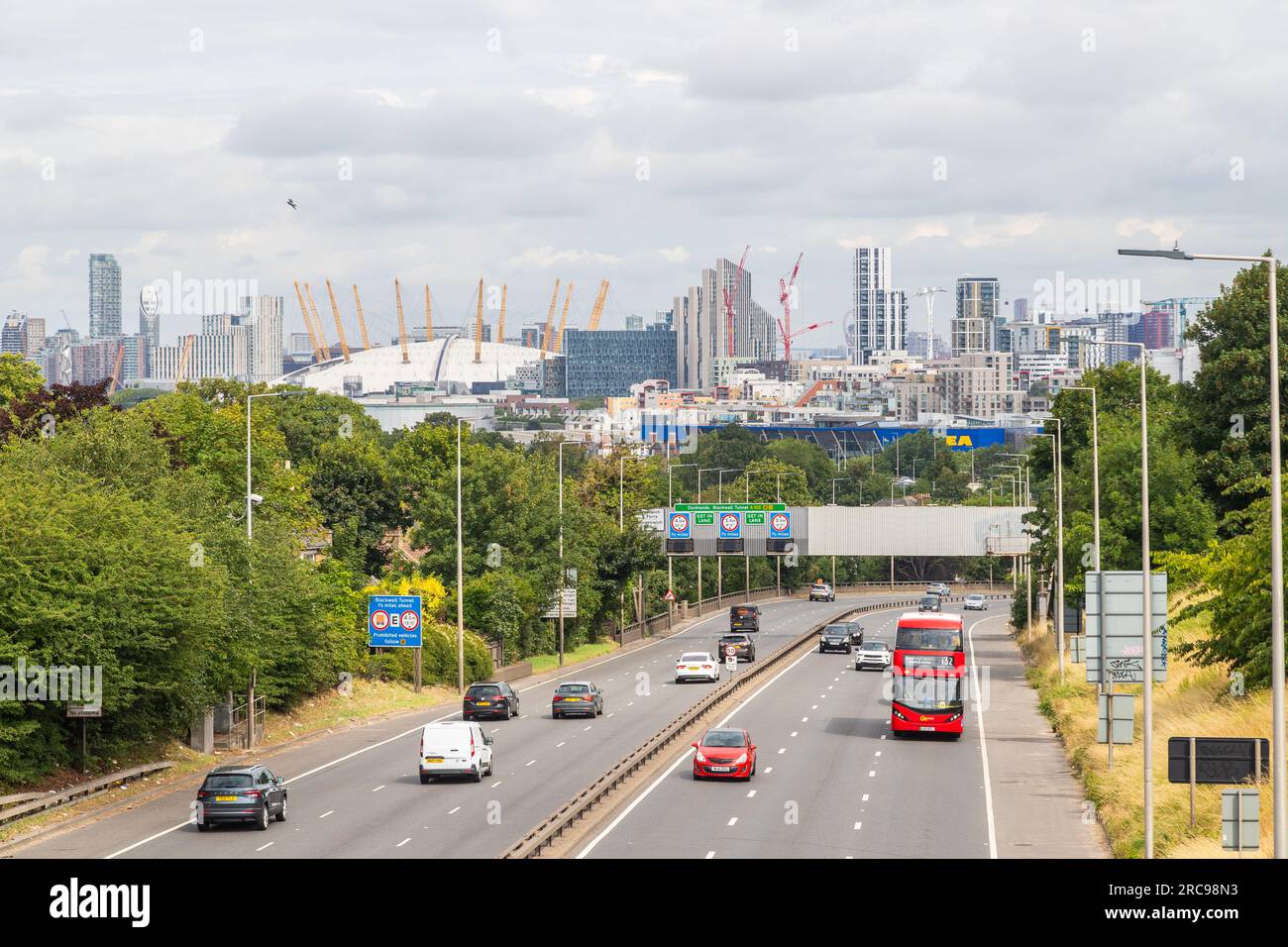LONDON, UK - 13TH JULY 2023: Traffic on the A2 road in South East London connecting with the Black Wall tunnel. Part of the O2 dome can be seen. Stock Photo