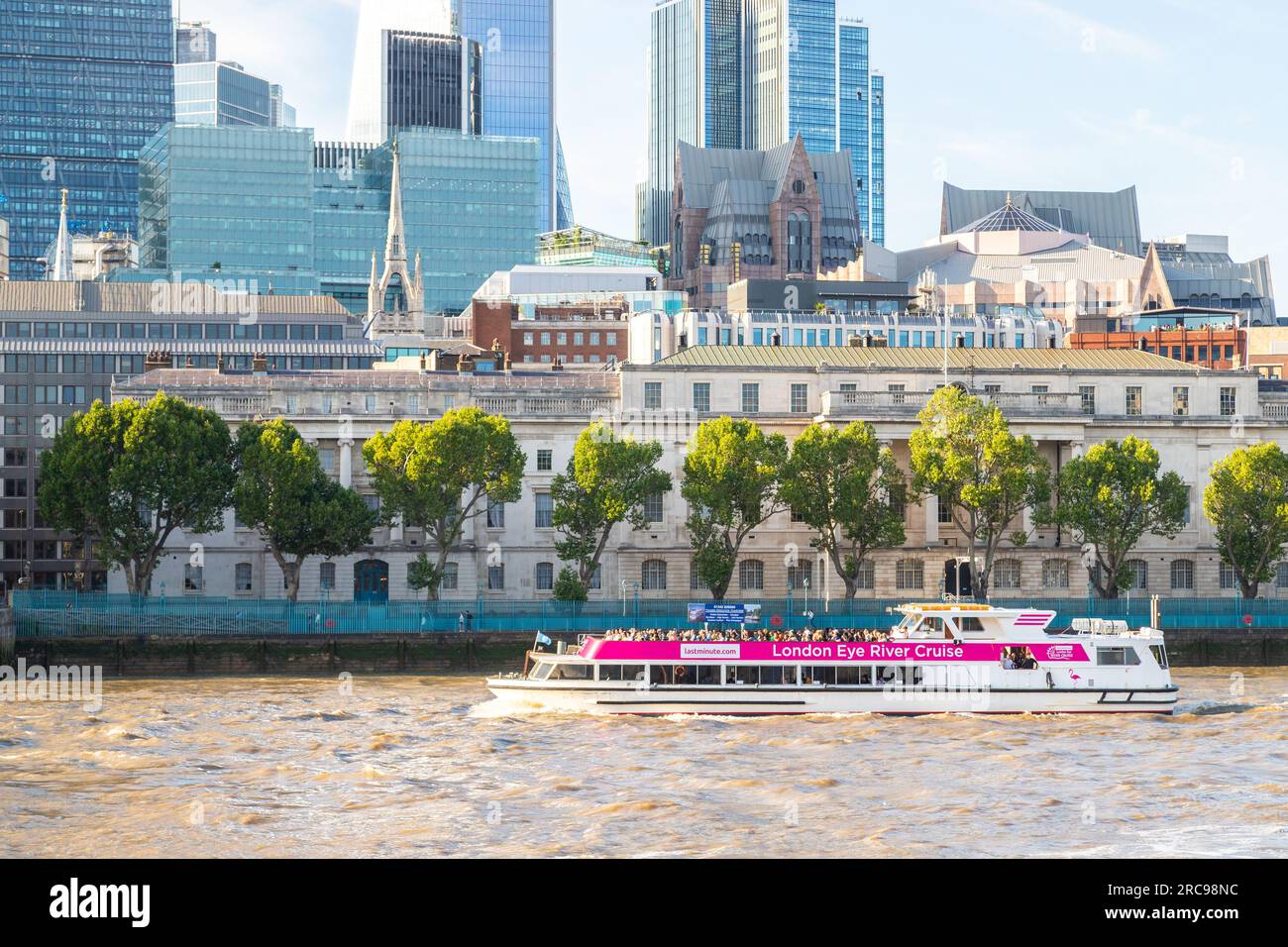LONDON, UK - 6TH JULY 2023: A London Eye River Cruise boat along the River Thames in central London during the day. People can be seen on the boat and Stock Photo
