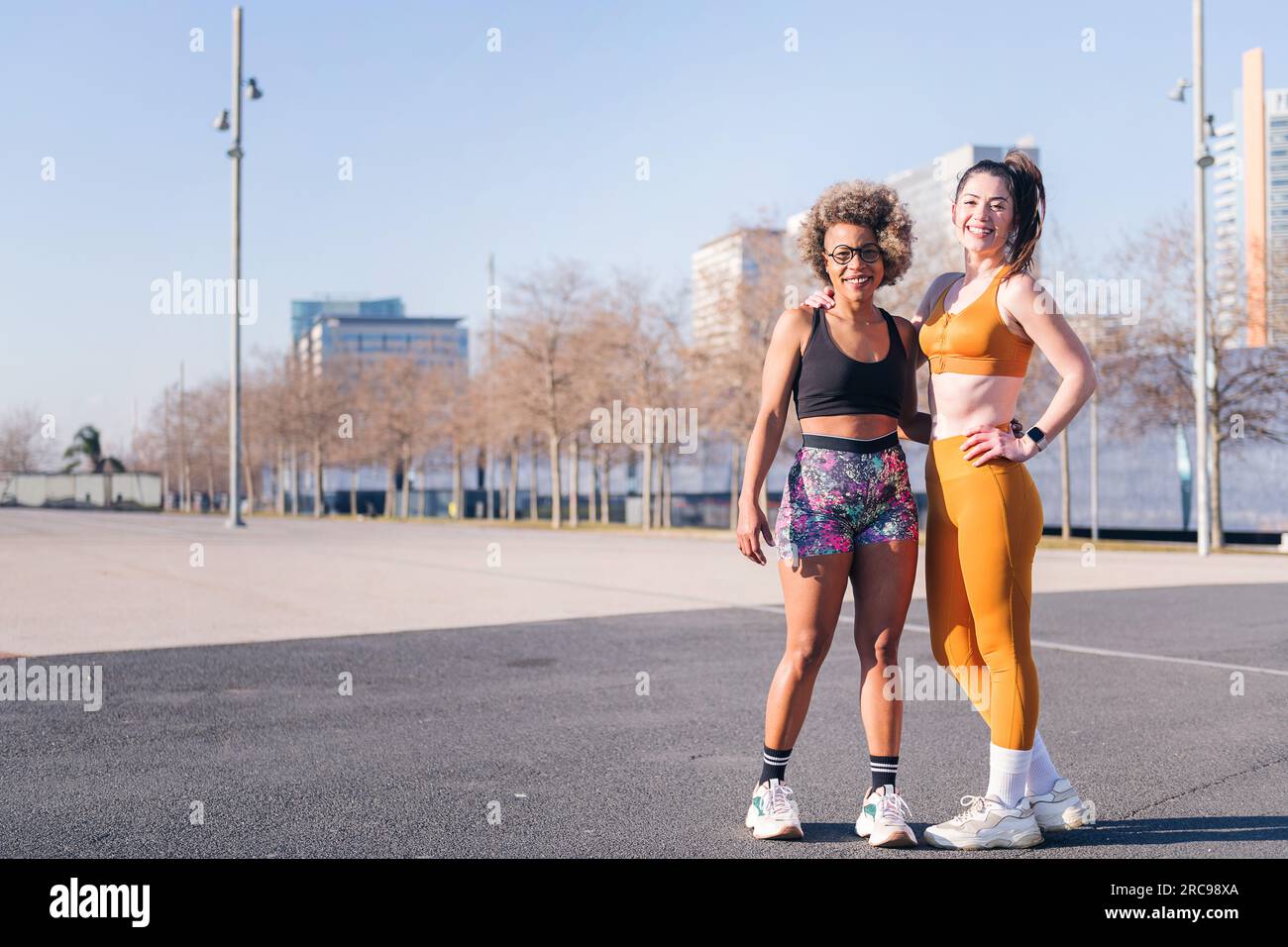 two multiethnic sportive friends looking at camera Stock Photo