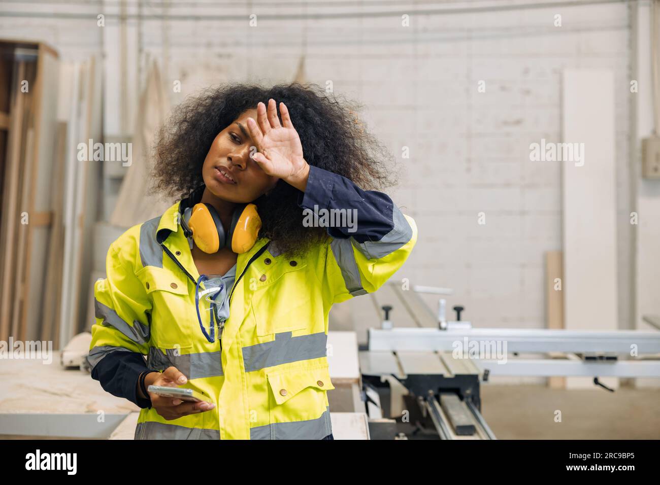 Tired women factory worker. sweat exhausted engineer woman. fatigued hard work black african female labor staff working. hot workplace Stock Photo