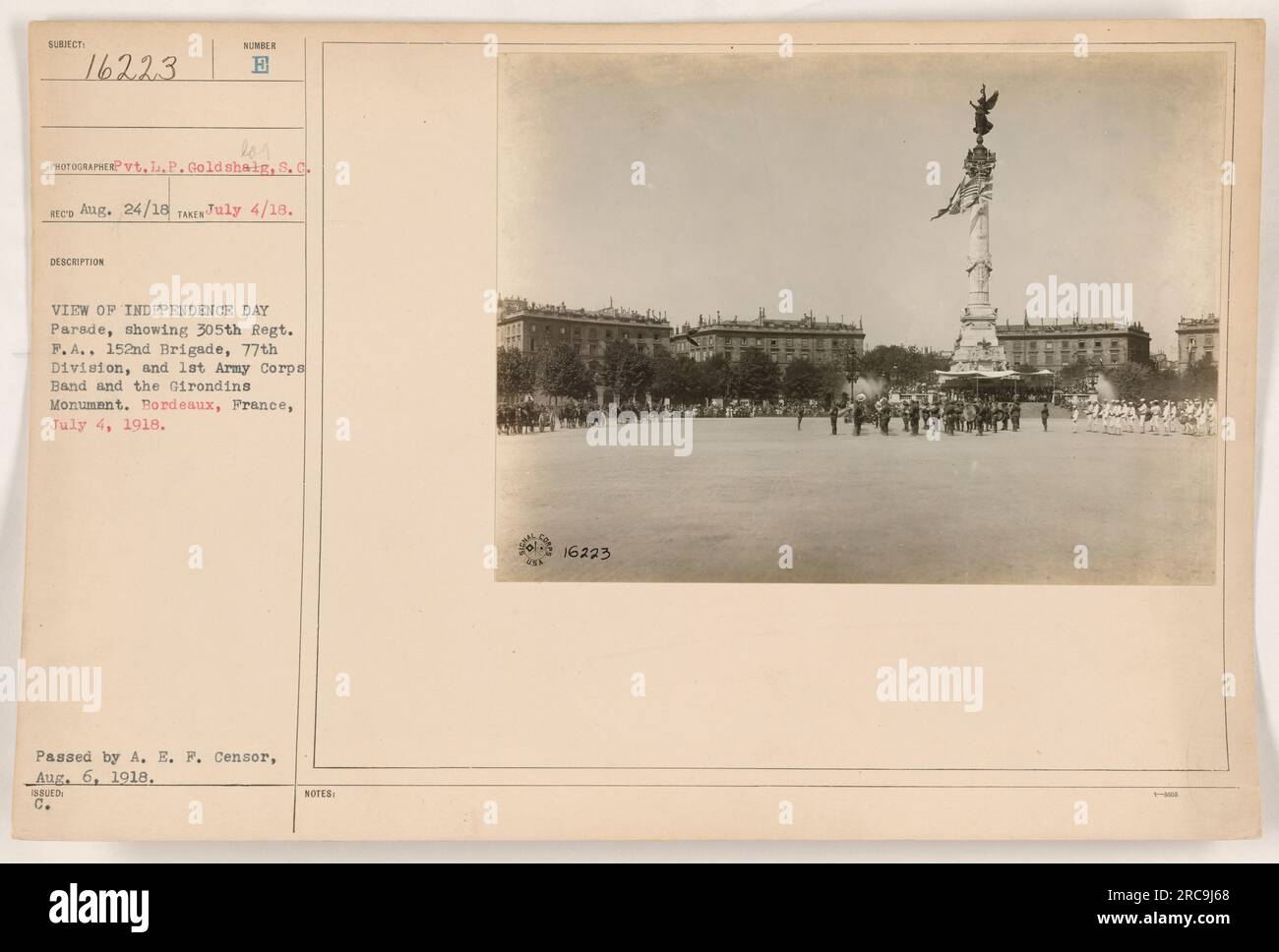 The image shows a view of an Independence Day Parade in Bordeaux, France on July 4, 1918. The parade includes the 305th Regiment, F.A., the 152nd Brigade, 77th Division, and the 1st Army Corps Band, along with the Girondins Monument. It was taken by Pvt. L.P. Goldshaig, S.C. and passed by A.E.F. Censor on August 6, 1918. Stock Photo