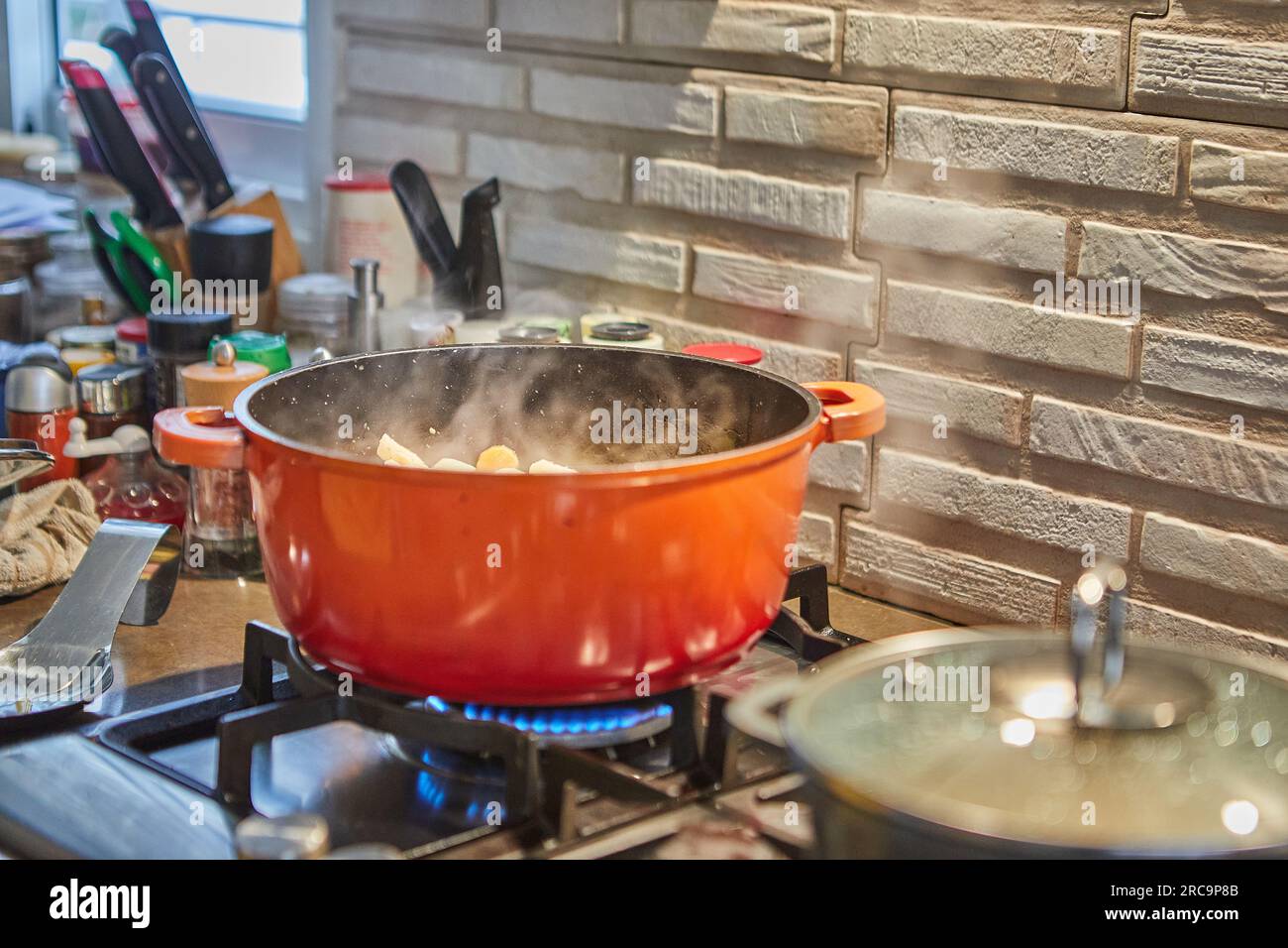 Pots with cooking food in the kitchen on gas stove Stock Photo - Alamy