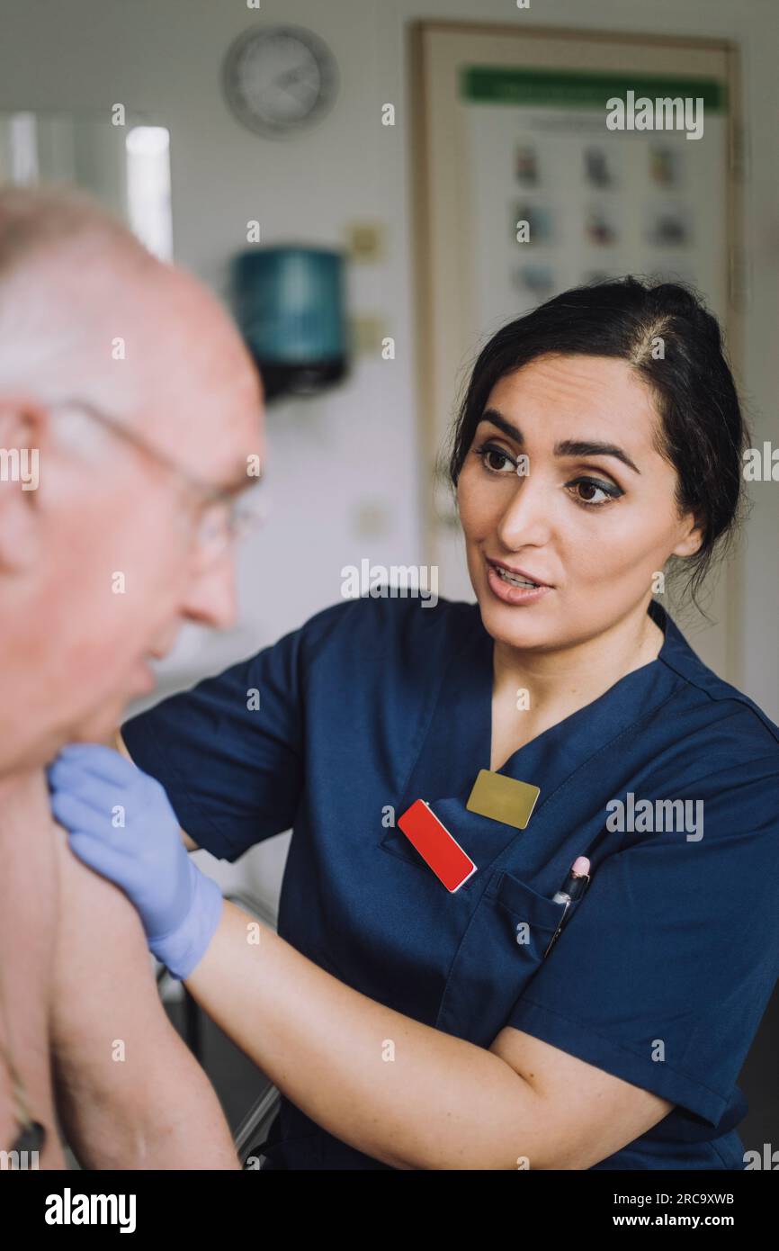 Female nurse talking to senior male patient at hospital Stock Photo - Alamy