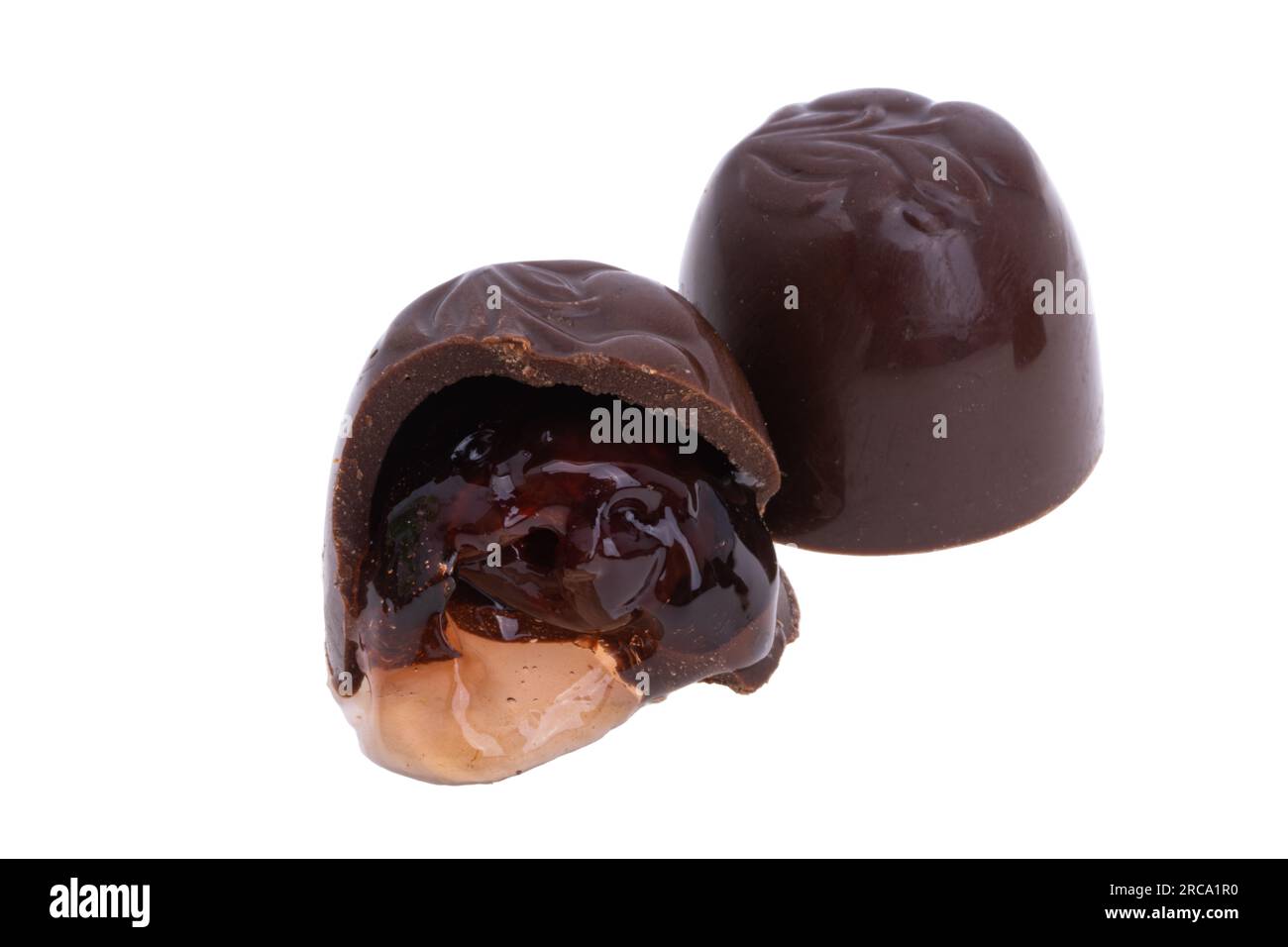 chocolate candies with cherries and liqueur isolated on white