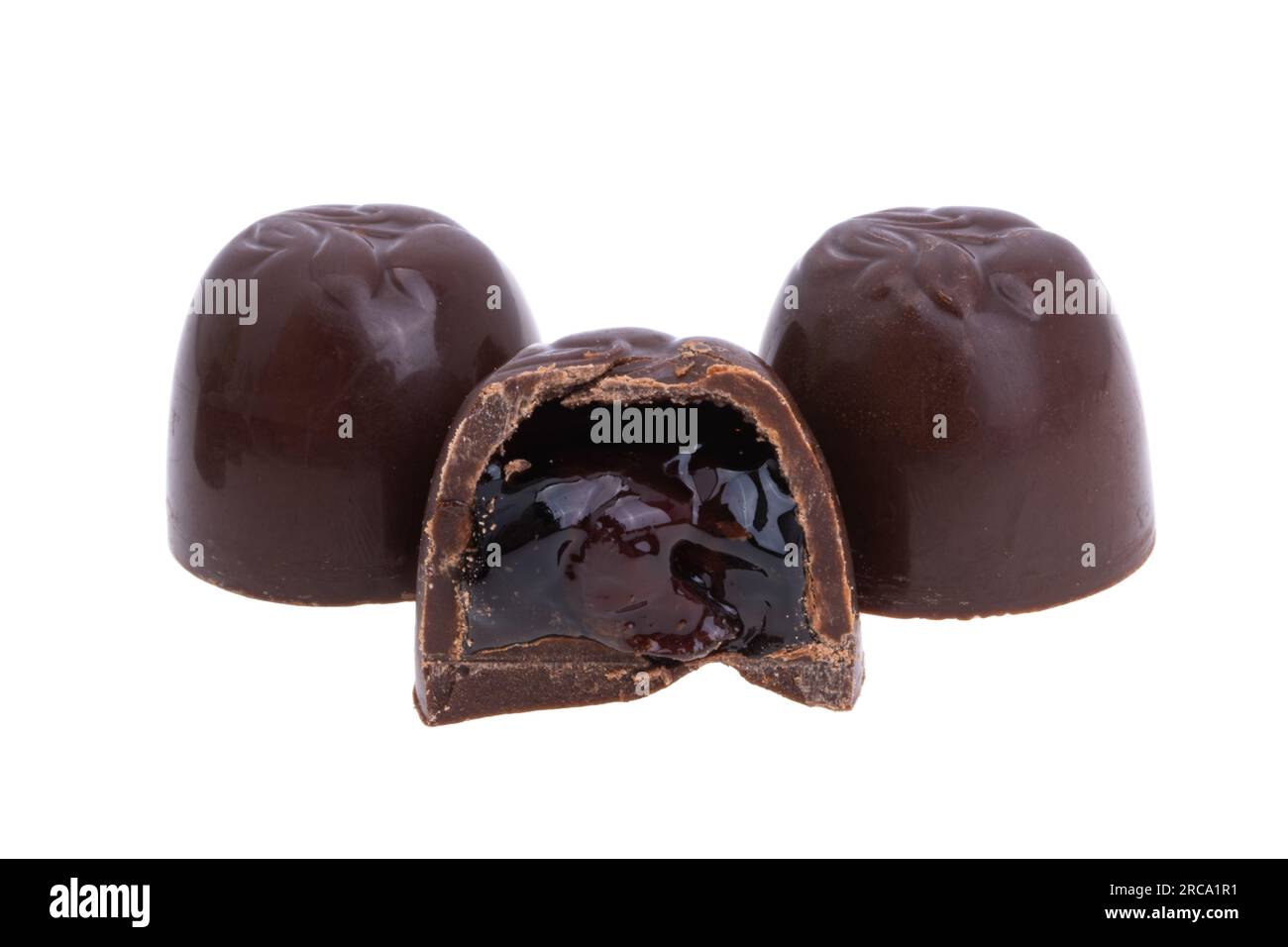 chocolate candies with cherries and liqueur isolated on white