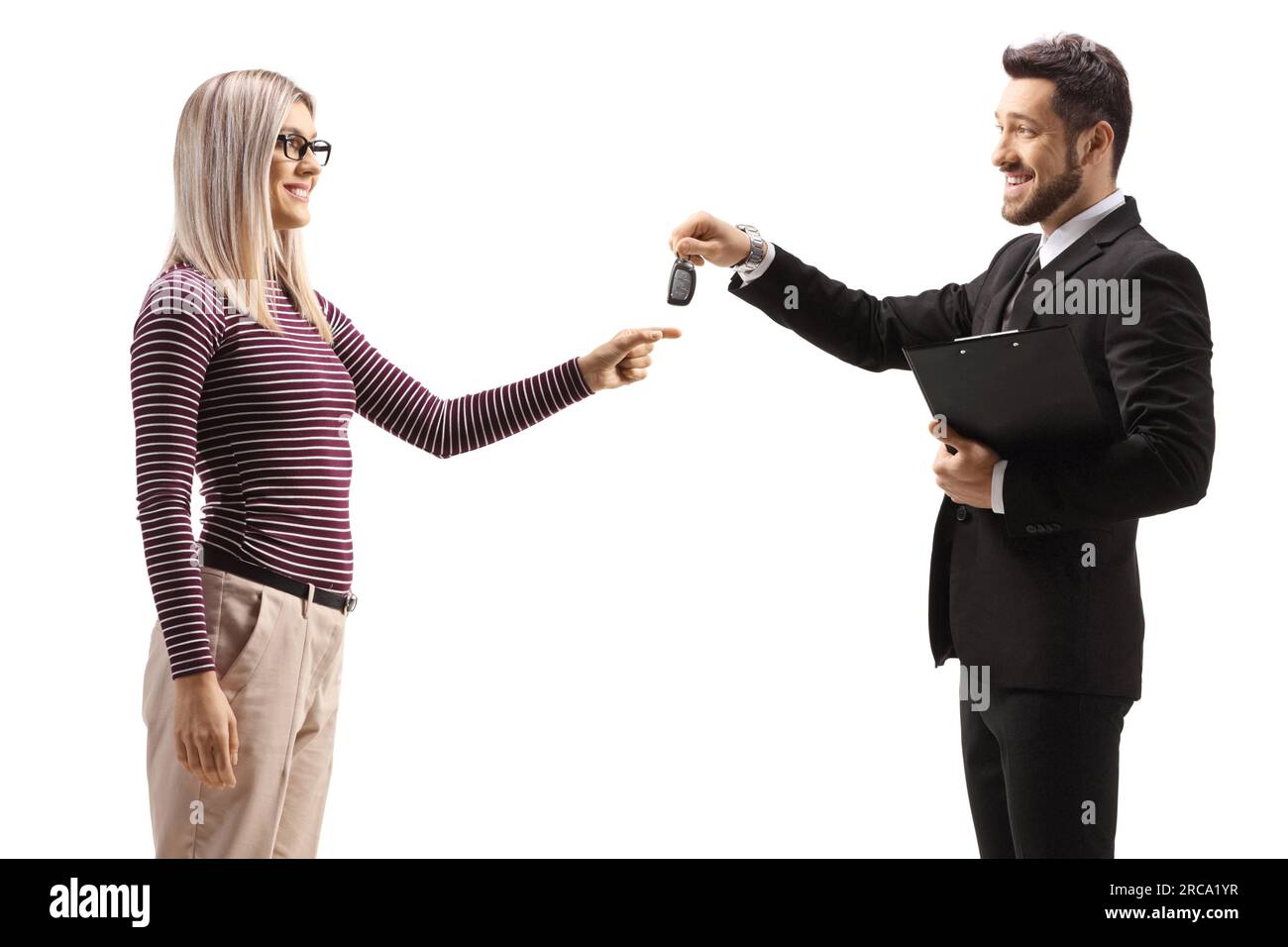 Businessman giving car keys to a young woman isolated on white background Stock Photo