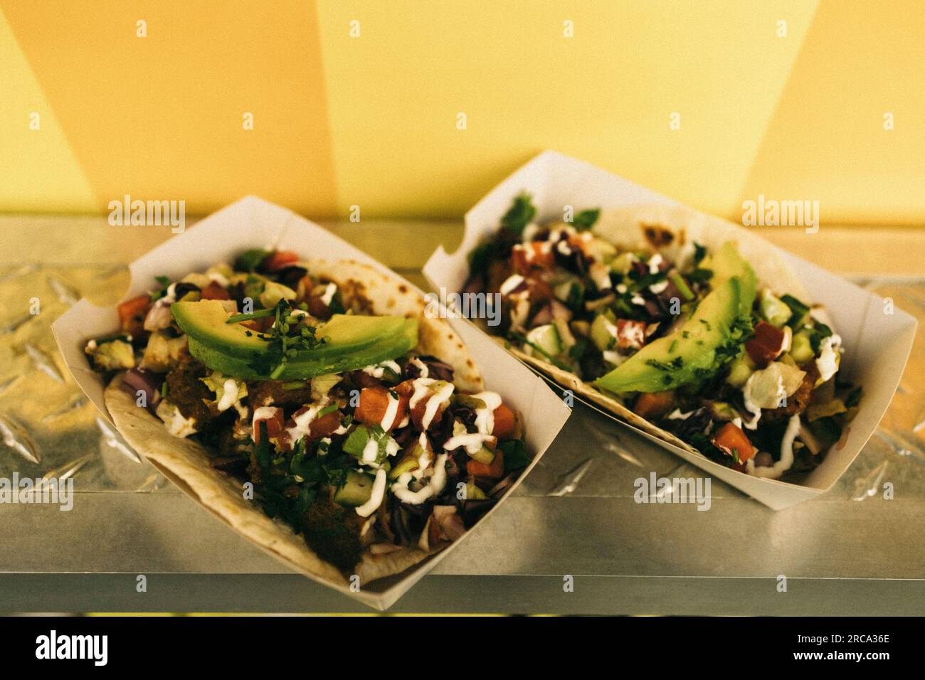 Pair of fresh tacos in take away boxes on concession stand Stock Photo
