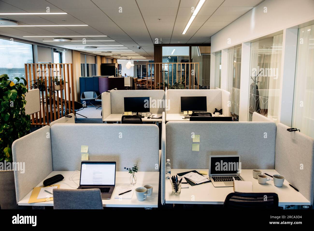 Empty tables with laptops in modern coworking office Stock Photo