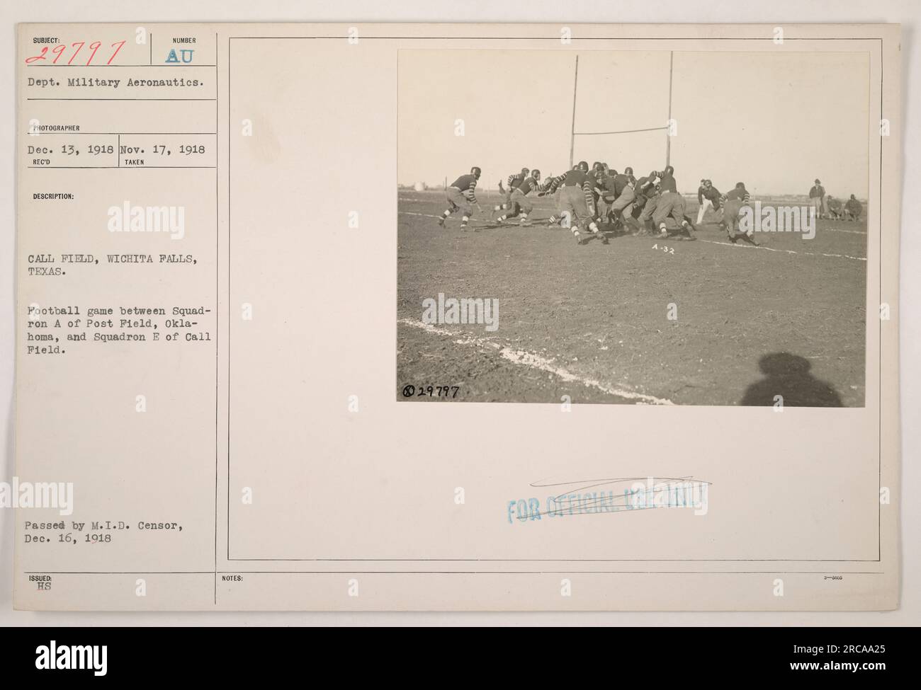 This photograph shows a football game between Squad-Iron A of Post Field, Oklahoma, and Squadron E of Call Field at Call Field, Wichita Falls, Texas. The image was taken on November 17, 1918, and was passed by the M.I.D. Censor on December 16, 1918. The photograph belongs to the AU Department of Military Aeronautics and is labeled as number 29797. Stock Photo