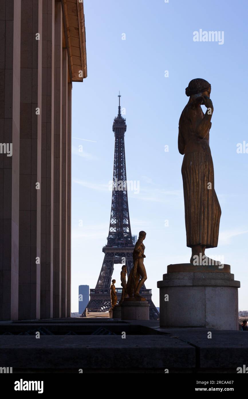 View of gold Sculptures on the Palais de Chaillot in the Trocadero site with Eiffel Tower on background in Paris. France Stock Photo