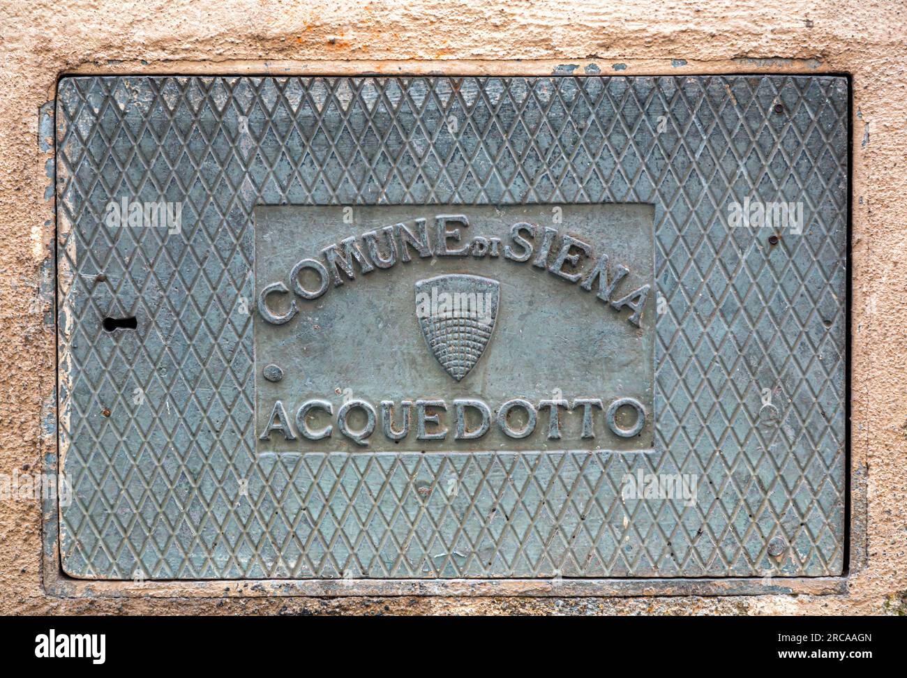 Siena, Italy - APR 7, 2022: Water sewage manhole cover with the Commune of Siena logo in Siena, Italy Stock Photo