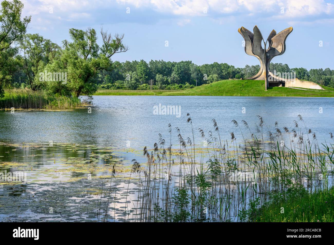 Looking across the lake to the Memorial at the site of the concentration camp run by the Ustasa regime during  world war II at Jasenovac in the Lonjsk Stock Photo