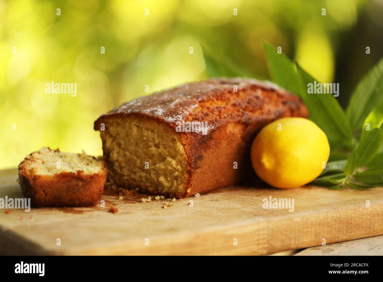 Lemon Drizzle Cake on a wooden board Stock Photo