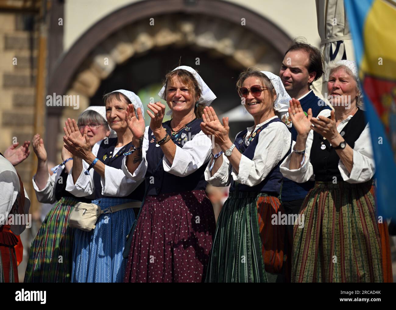 Gotha, Germany. 13th July, 2023. Women in traditional costume clap to