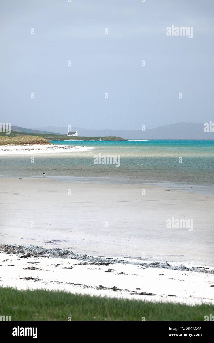 Traigh Mhor beach and cottage at Ardmore, Ardmhor on the north end of Barra, Outer Hebrides, Scotland. Looking NE Stock Photo