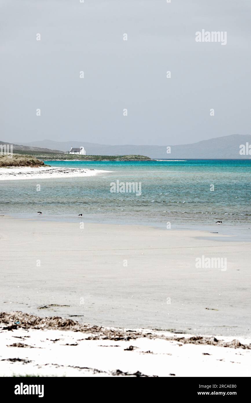 Traigh Mhor beach and cottage at Ardmore, Ardmhor on the north end of Barra, Outer Hebrides, Scotland. Looking NE Stock Photo