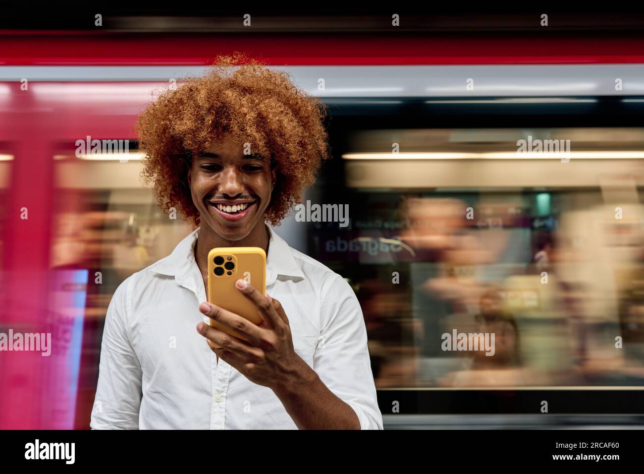 young afro hair man using smartphone while commuting in Subway - clean transportation concept Stock Photo