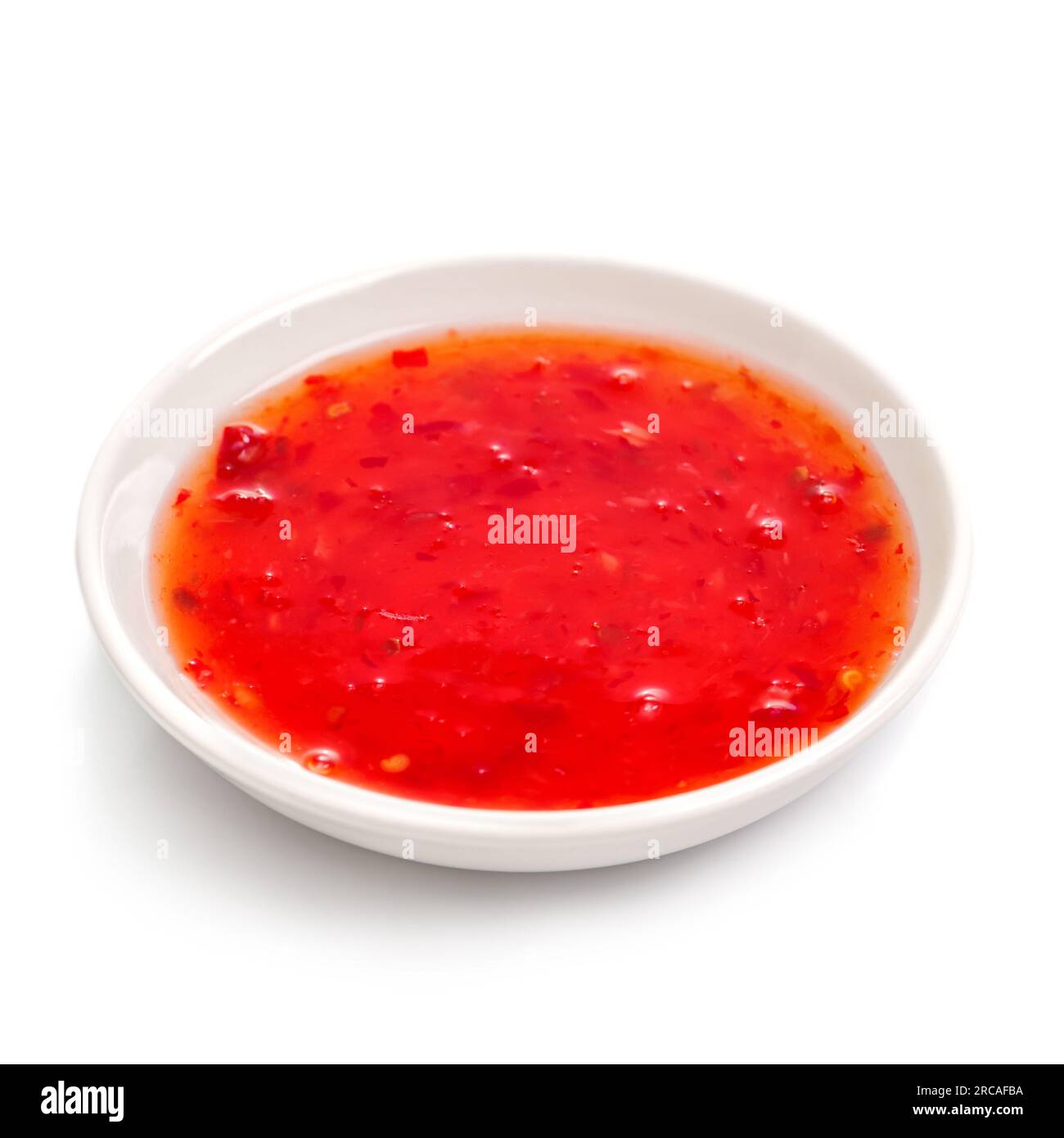 Sweet chilli sauce in a white ceramic bowl isolated on white. For the