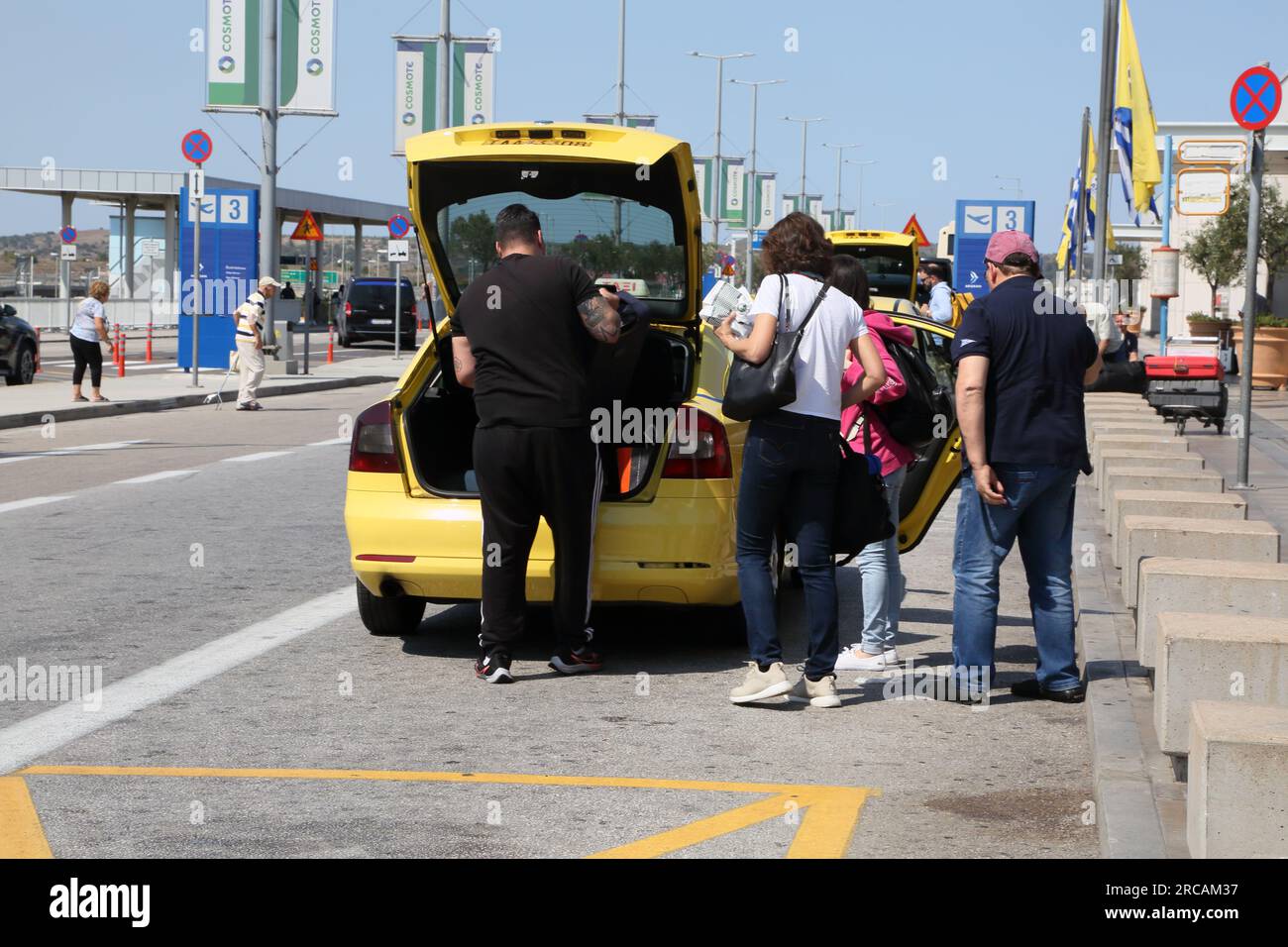 Athens Greece Athens International Airport (AIA) Eleftherios Venizelos Family Loading Luggage into Taxi Stock Photo