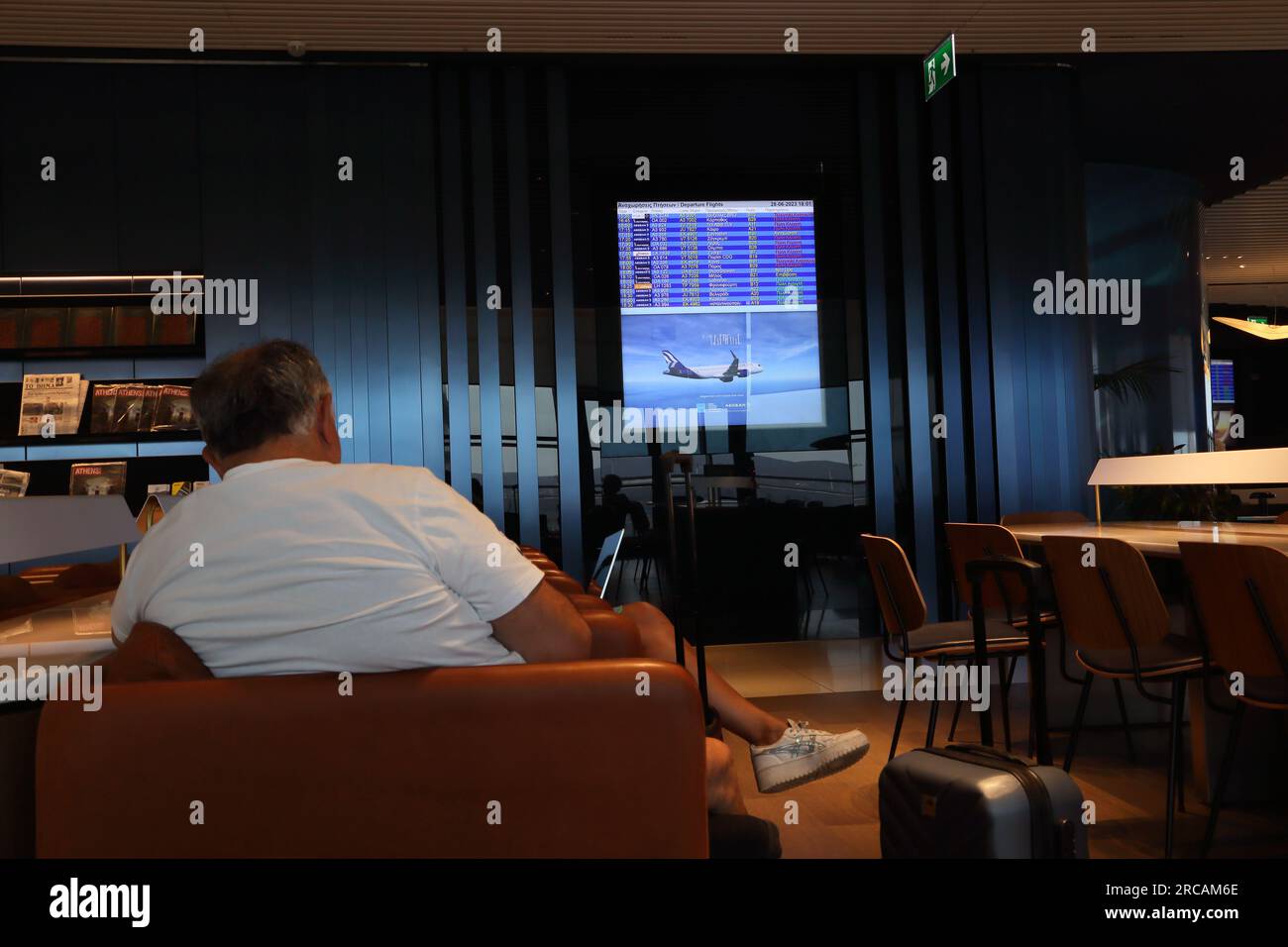 Athens Greece Athens International Airport (AIA) Eleftherios Venizelos Man Waiting in Executive Lounge Electronic Departures Stock Photo