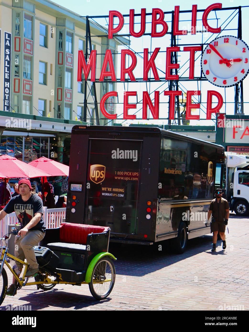 Sign Public Market Centre and clock at Pike Place Market with a UPS