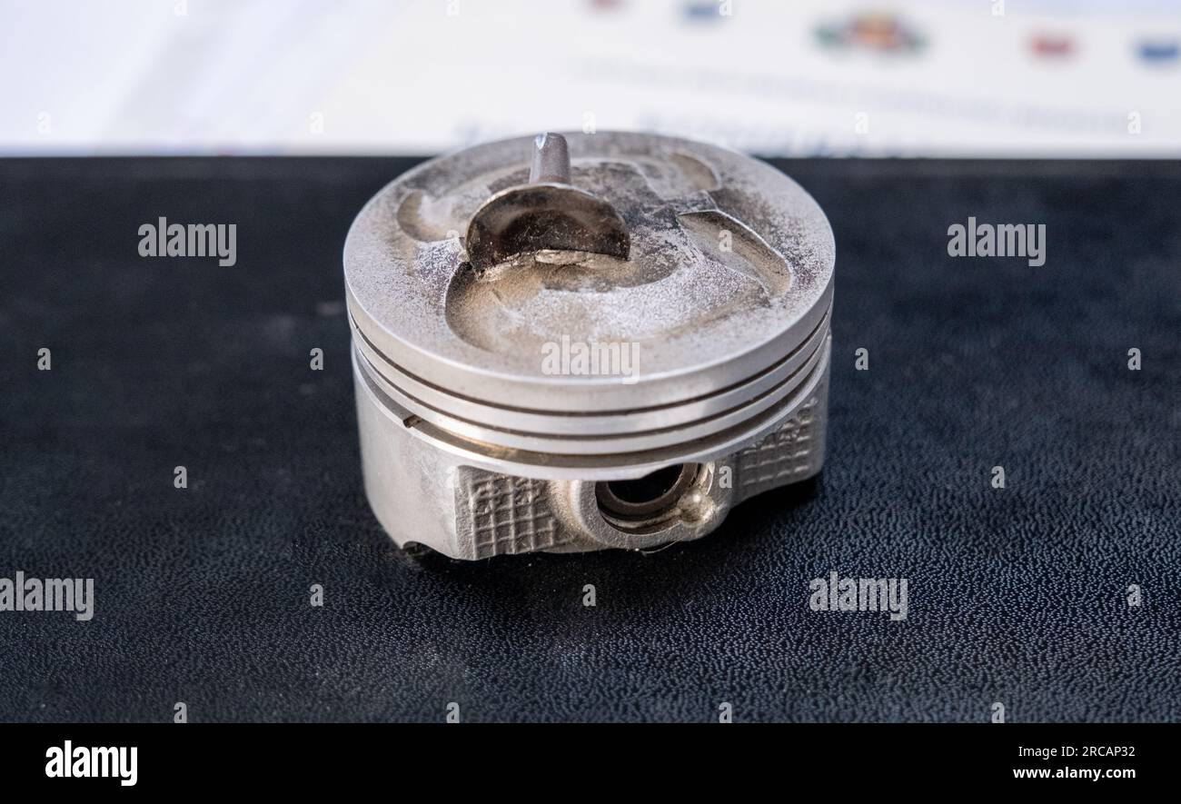 Broken connecting rod and engine piston isolated on white background